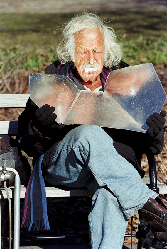 Man sunbathing with reflector in NYC