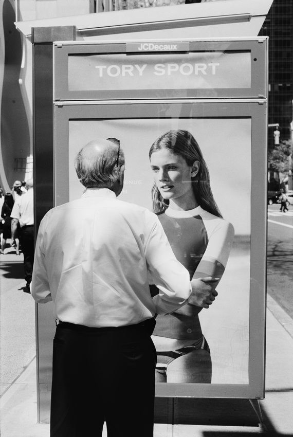 man looking at advertising with model